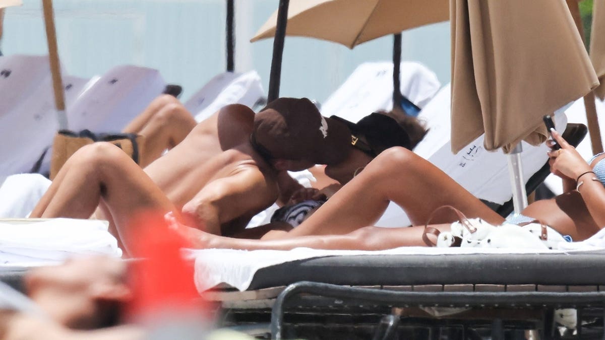 Jessica Alba and Danny Ramirez lounging on the shore and kissing in Miami in May 2026.