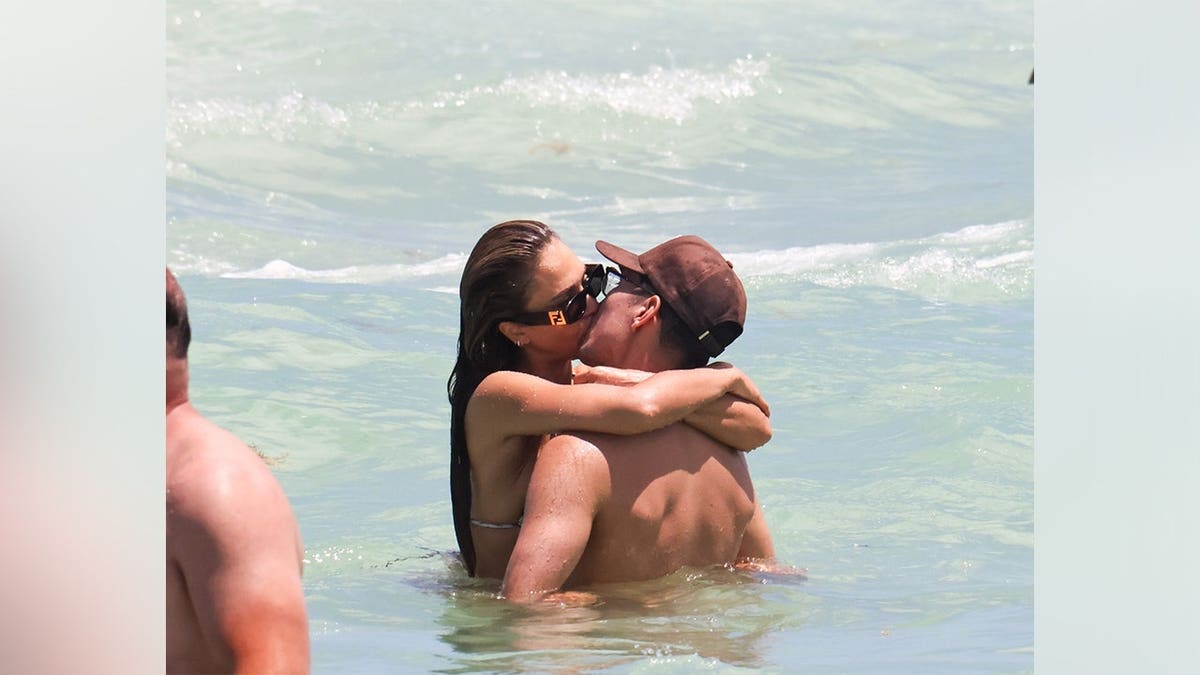 Jessica Alba and Danny Ramirez kissing while in the ocean in Miami in May 2026.