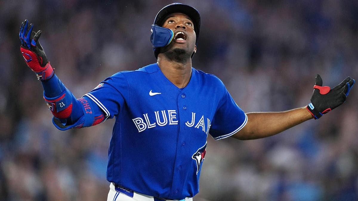 Toronto Blue Jays right fielder Jesus Sanchez celebrating after hitting a grand slam home run.