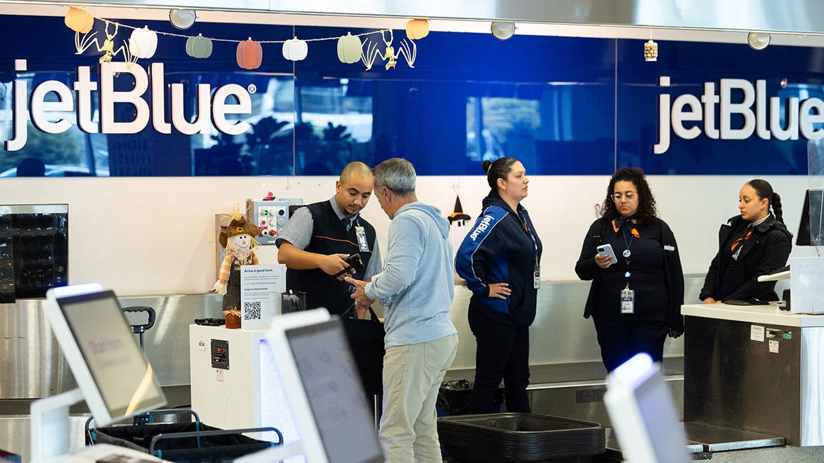 A traveler standing in the JetBlue check-in area at Philadelphia International Airport