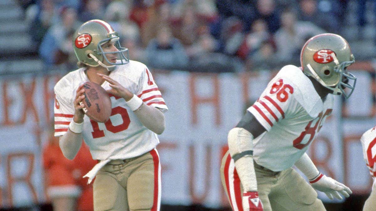 Quarterback Joe Montana looking to pass during a football game at Riverfront Stadium