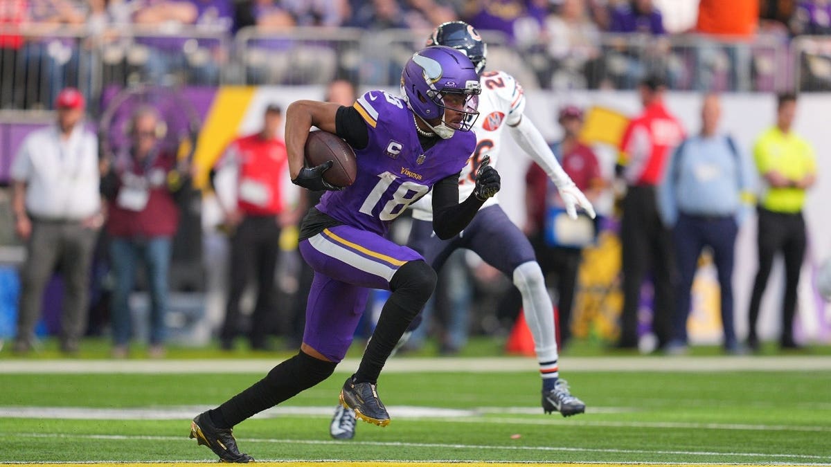 Minnesota Vikings WR Justin Jefferson runs with the ball after a catch against the Chicago Bears at US Bank Stadium.
