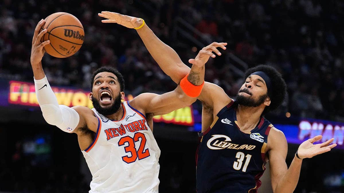 New York Knicks center Karl-Anthony Towns shooting against Cleveland Cavaliers center Jarrett Allen