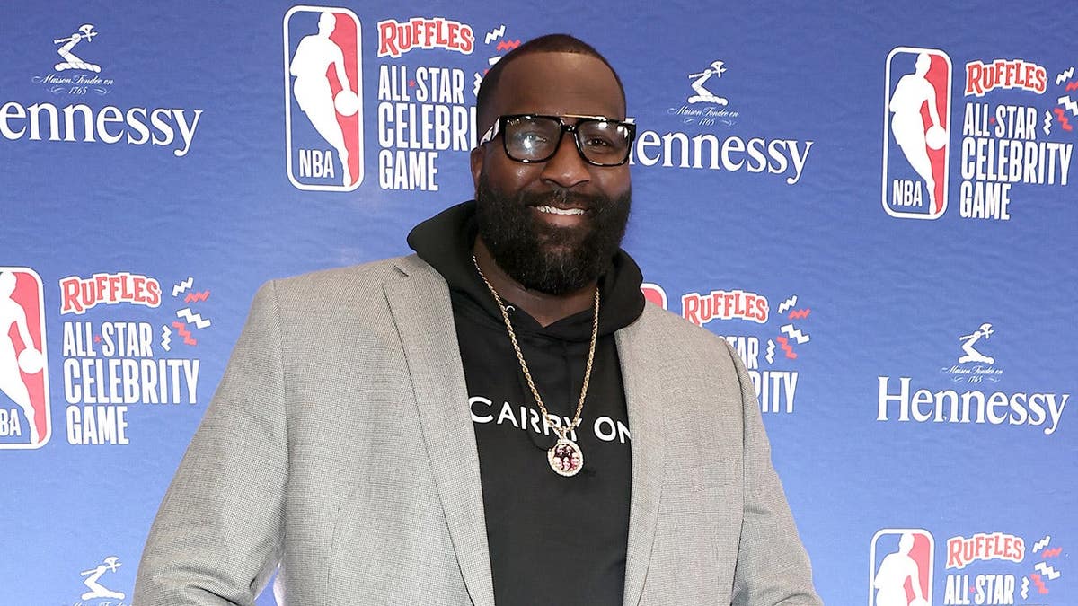 Kendrick Perkins stands on the basketball court at the NBA All-Star Celebrity Game