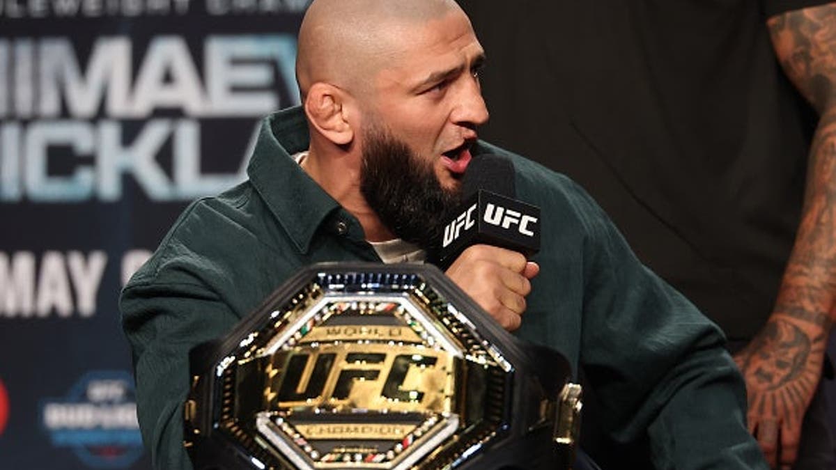 Khamzat Chimaev standing on stage during UFC 328 press conference in Newark, New Jersey