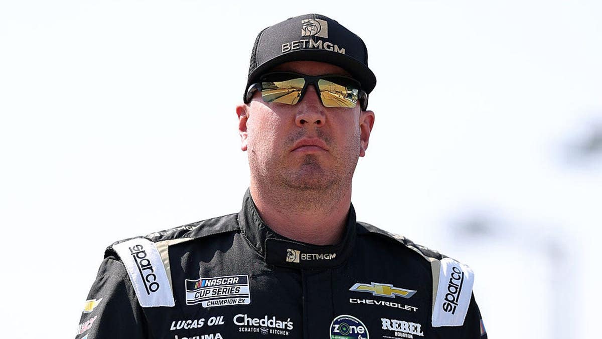 Kyle Busch walking the grid at Darlington Raceway during NASCAR qualifying.