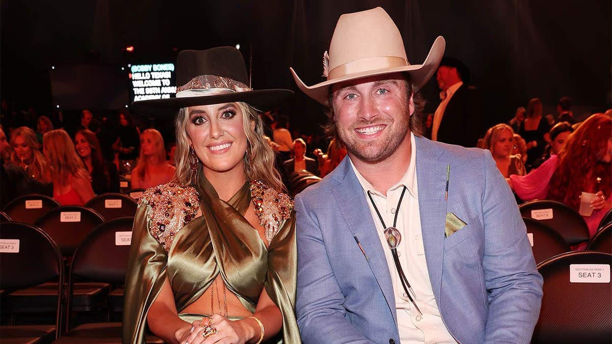 Lainey Wilson and Devlin Hodges posing together at the Academy of Country Music Awards