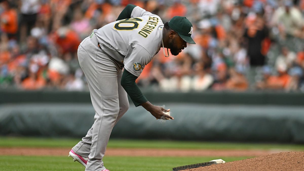 Athletics starting pitcher Luis Severino using a rosin bag on the mound during a baseball game