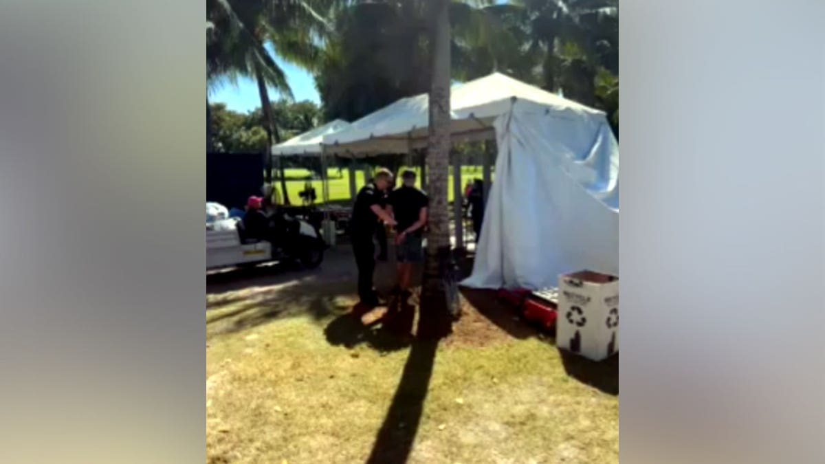police arresting a man at Trump National Doral