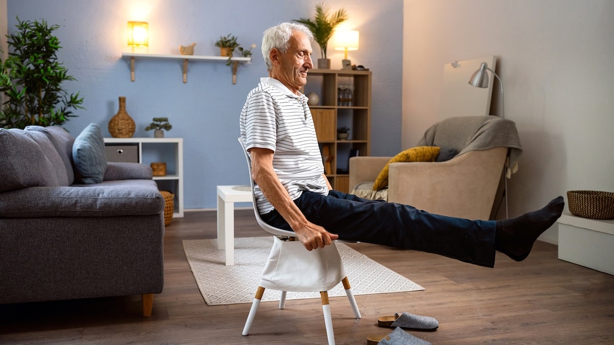 Senior man exercising at home