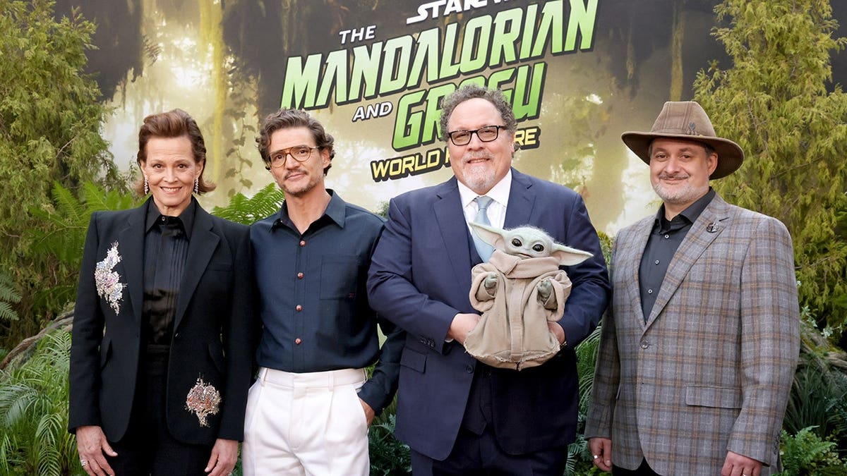 Sigourney Weaver, Pedro Pascal, Jon Favreau and Dave Filoni stand together at the Los Angeles premiere of The Mandalorian and Grogu