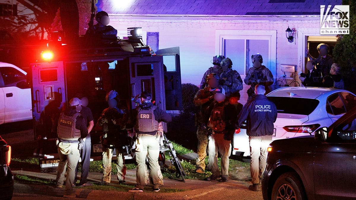 Law enforcement agents during an immigration raid in Manassas, Va., on May 15, 2026.