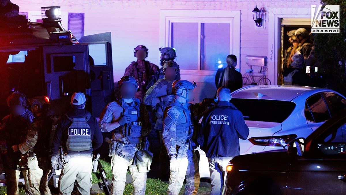 Law enforcement agents during an immigration raid in Manassas, Va., on May 15, 2026.