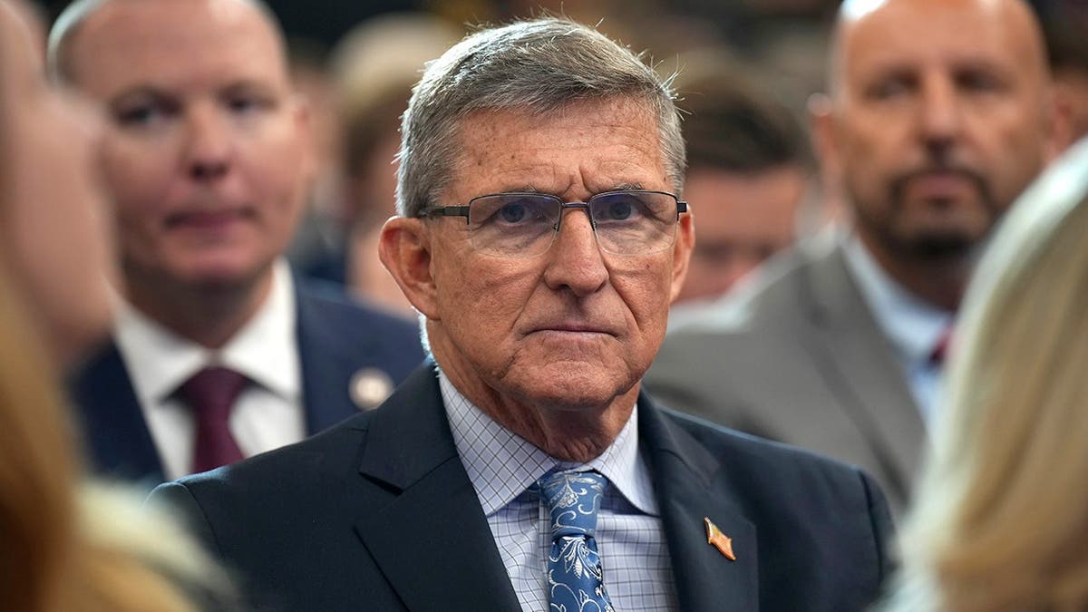 Michael Flynn looks on before Trump remarks at Justice Department.