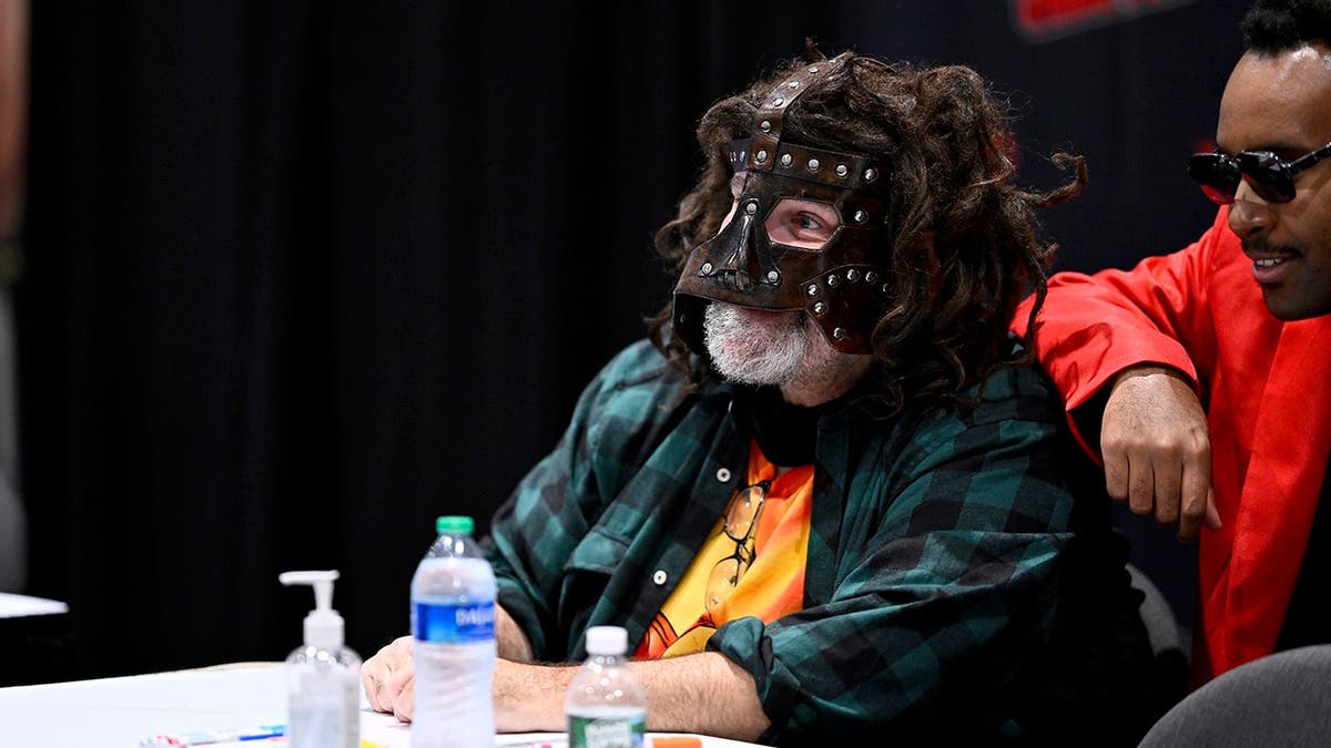 Mick Foley posing with a guest at New York Comic Con in New York City