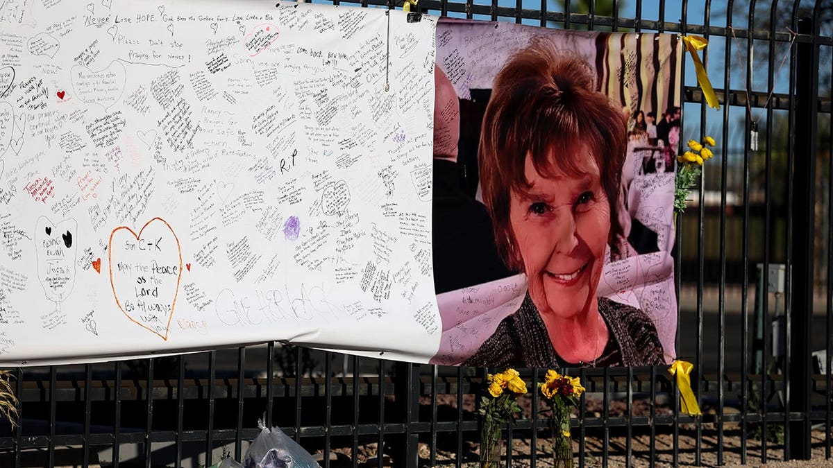 Photograph of Nancy Guthrie displayed on a sign for messages in Tucson, Arizona