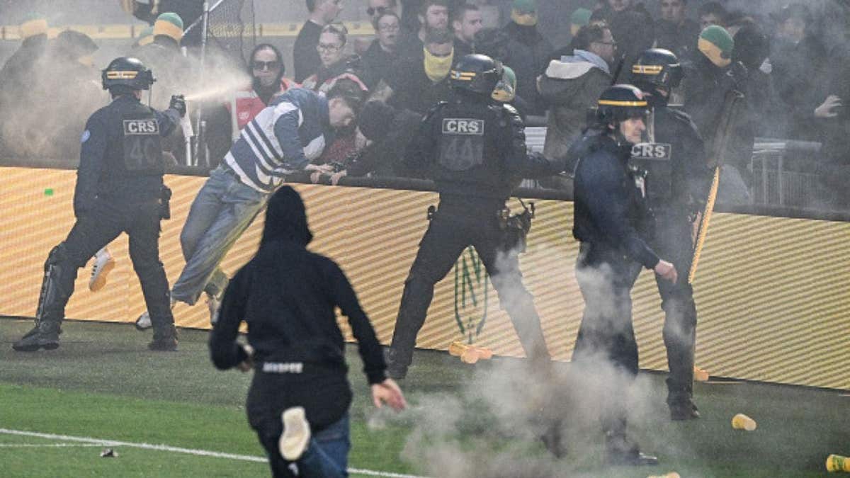 Riot police officers spray tear gas at Nantes fans trying to invade the pitch during the French L1 soccer match between FC Nantes and Toulouse FC at the Stade de la Beaujoire Louis Fonteneau in Nantes, western France, on May 17, 2026. (Photo by Sebastien Salom-Gomis/AFP via Getty Images)
