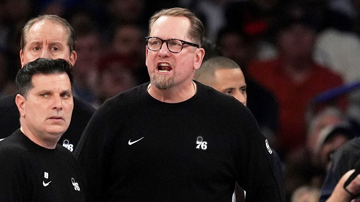 Philadelphia 76ers coach Nick Nurse yelling during a timeout in a basketball game.