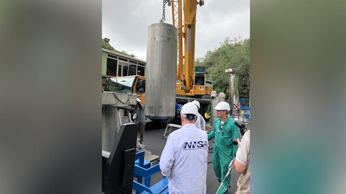NNSA technical experts overseeing the loading of nuclear fuel into the specialized spent nuclear fuel cask.