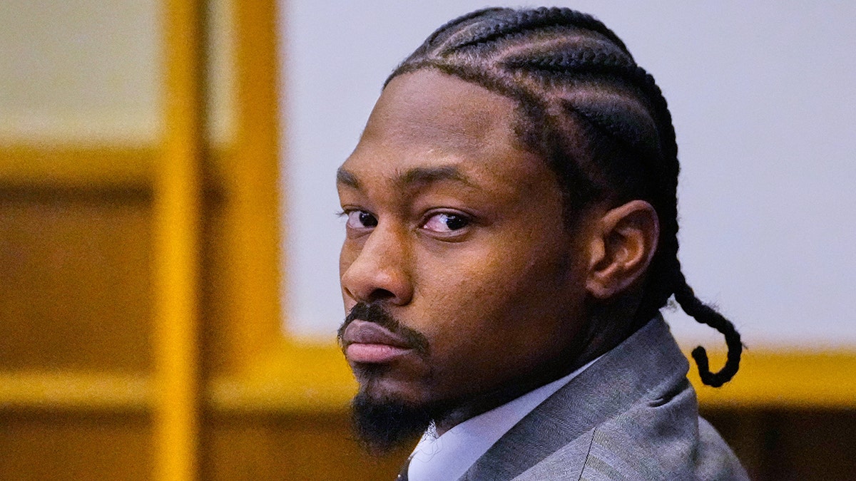Stefon Diggs seated in courtroom listening to defense attorney cross-examining witness