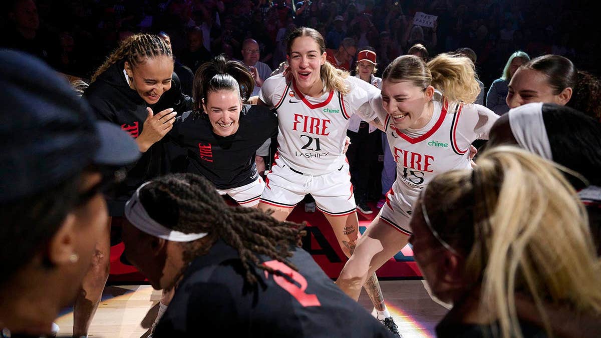 Portland Fire players Haley Jones, Bridget Carleton, Emily Engstler, and Luisa Geiselsoder huddle before a game.