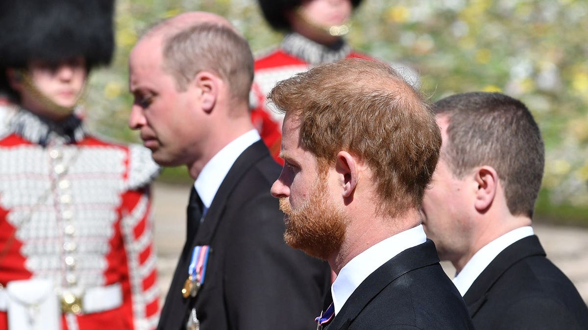 Prince William, Prince Harry, and Peter Phillips walking behind Prince Philip's coffin at Windsor Castle