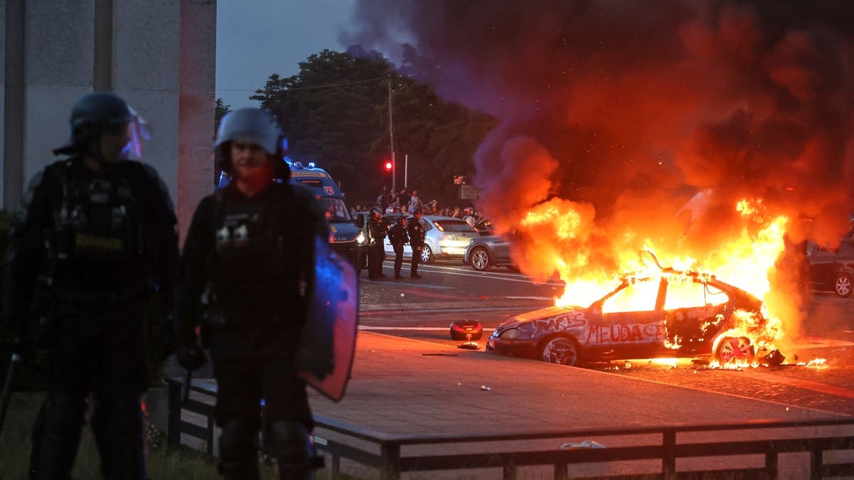 A car burns as PSG supporters celebrate in Paris, Saturday, May 30, 2026 after the Champions League final soccer match between Paris Saint-Germain and Arsenal.