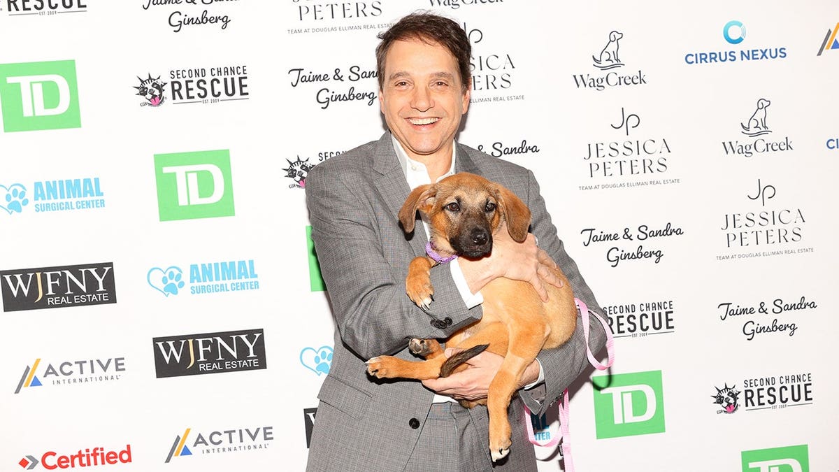 Ralph Macchio standing and smiling