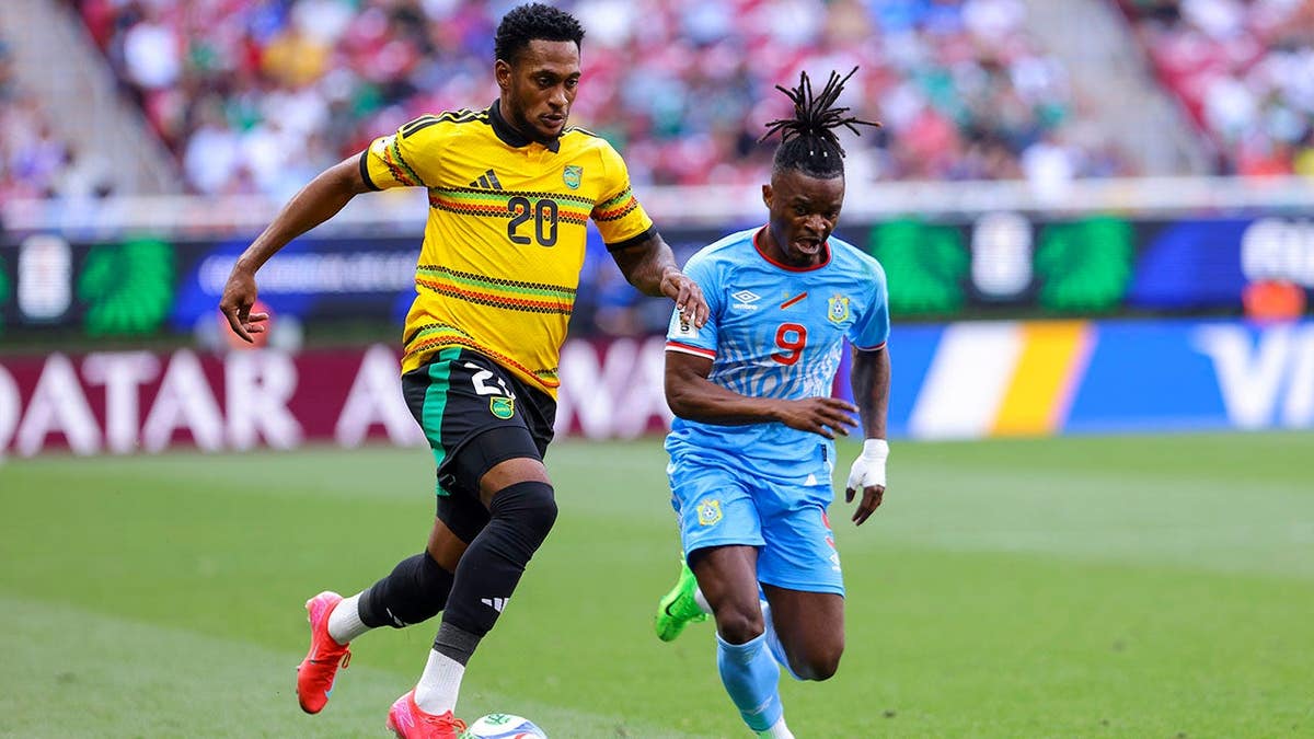 Renaldo Cephas and Brian Cipenga fighting for the ball during a soccer match