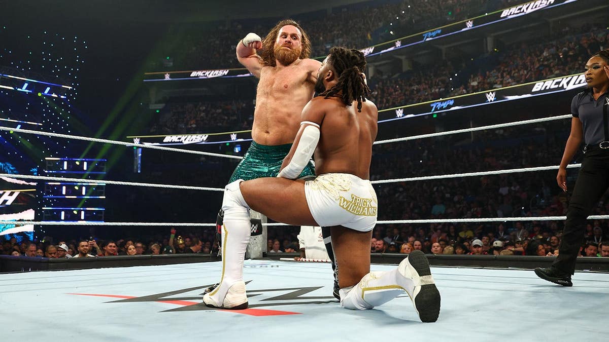Sami Zayn wrestling Trick Williams successful a WWE lucifer astatine Benchmark International Arena