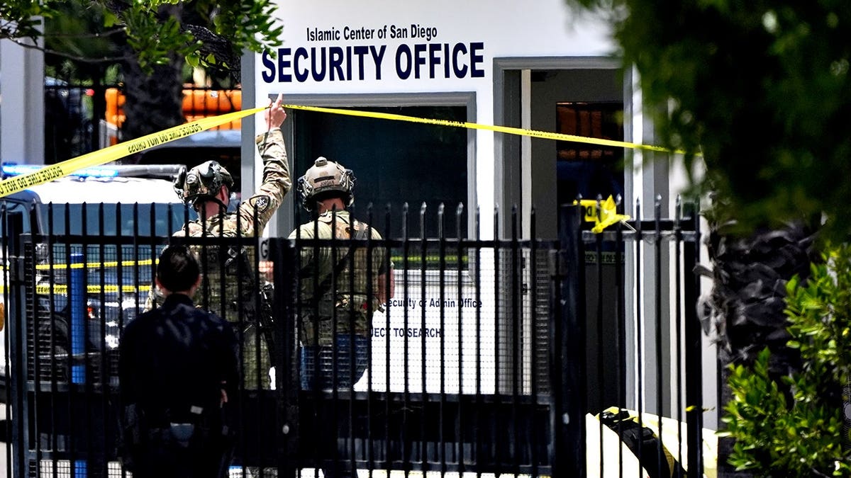 A body covered with a tarp at the scene outside the Islamic Center of San Diego