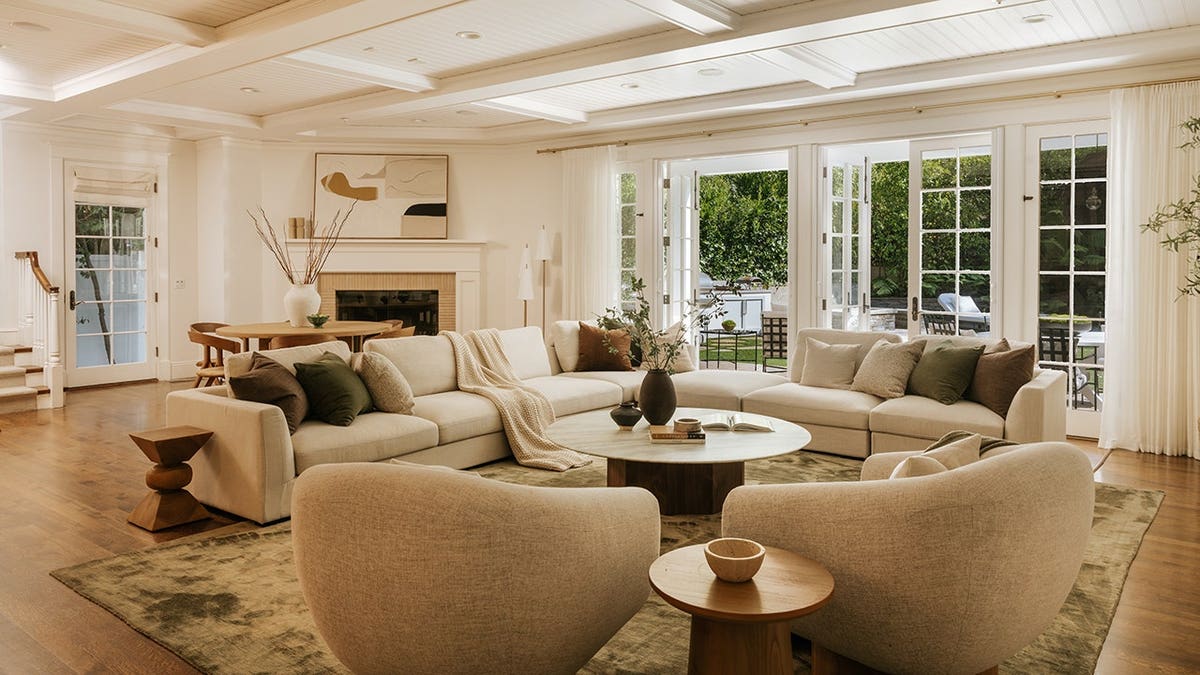 A large living room with access to the yard and a fireplace in the corner.