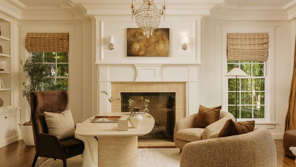 An at home office with a wood-burning fireplace.