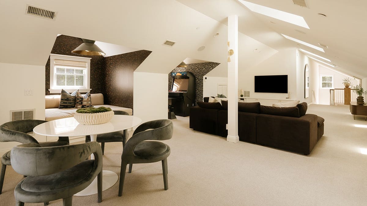 A spare room with a TV and arcade games.