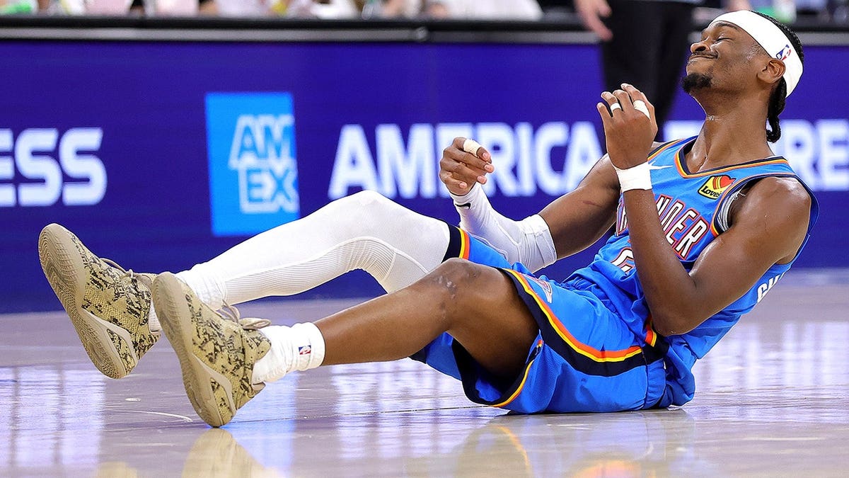 Shai Gilgeous-Alexander wearing Oklahoma City Thunder uniform reacting during basketball game