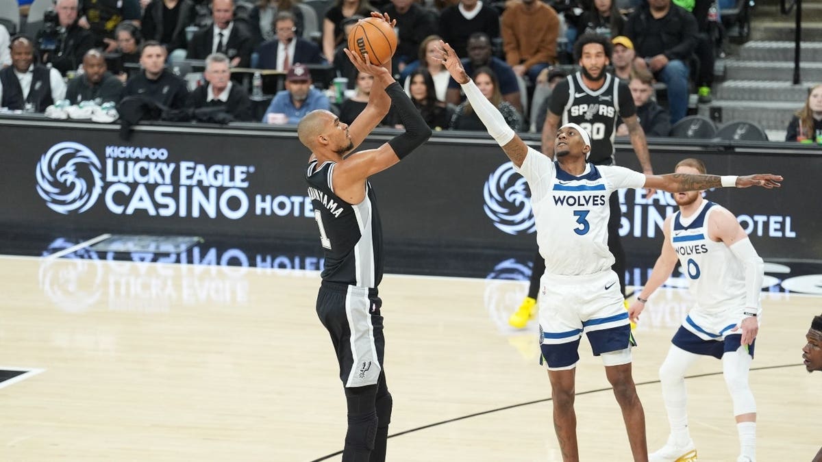 San Antonio Spurs C Victor Wembanyama shoots over Minnesota Timberwolves wing Jaden McDaniels at Frost Bank Center in Texas.
