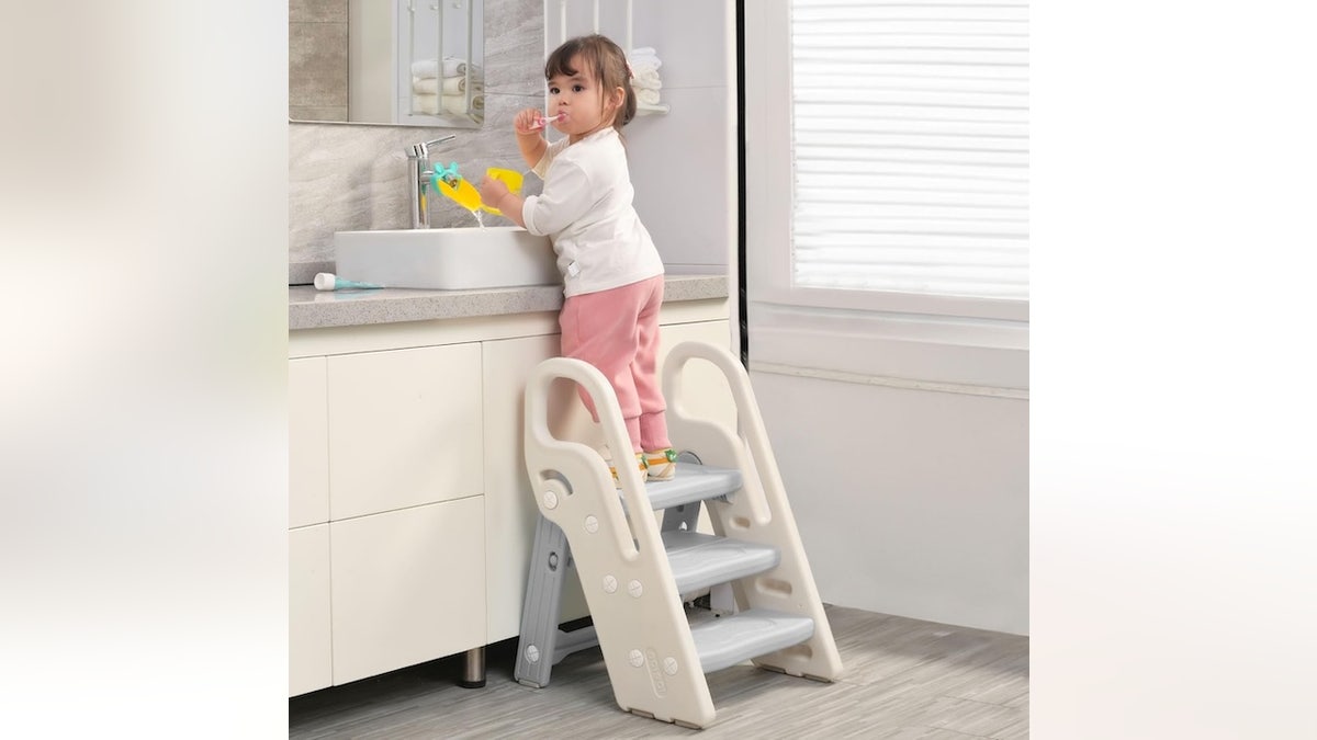 This foldable step stool helps kids safely reach sinks and counters.