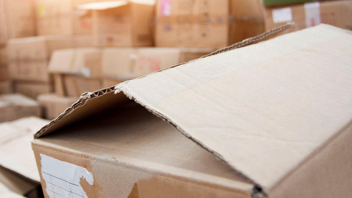 Long shelves filled with various boxes and containers in a storage area