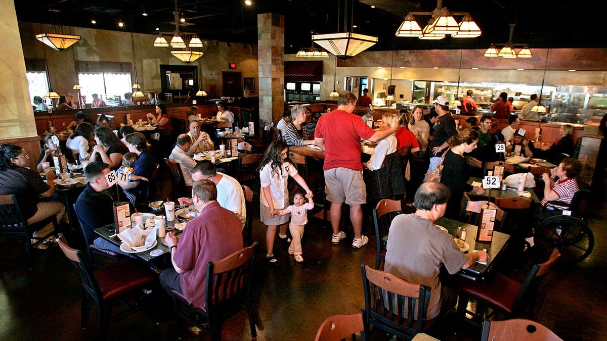 Customers dining inside Stonefire Grill restaurant in West Hills, California