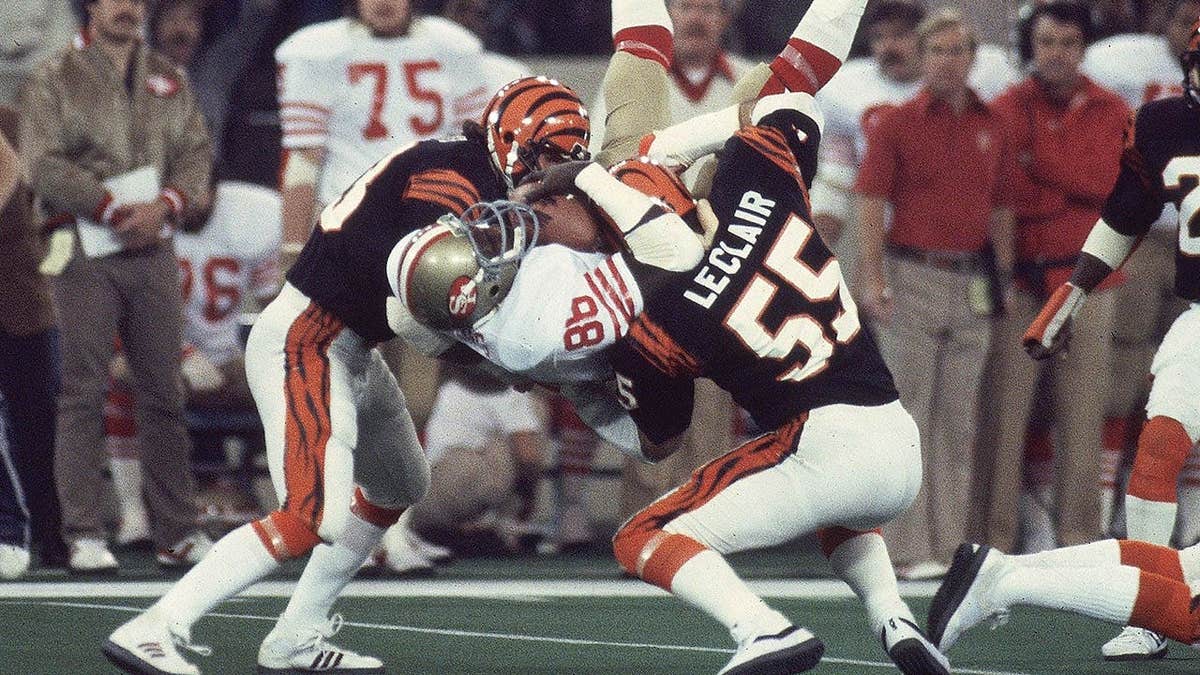 San Francisco 49ers Charles Young being tackled by Cincinnati Bengals Jim Leclair during football game