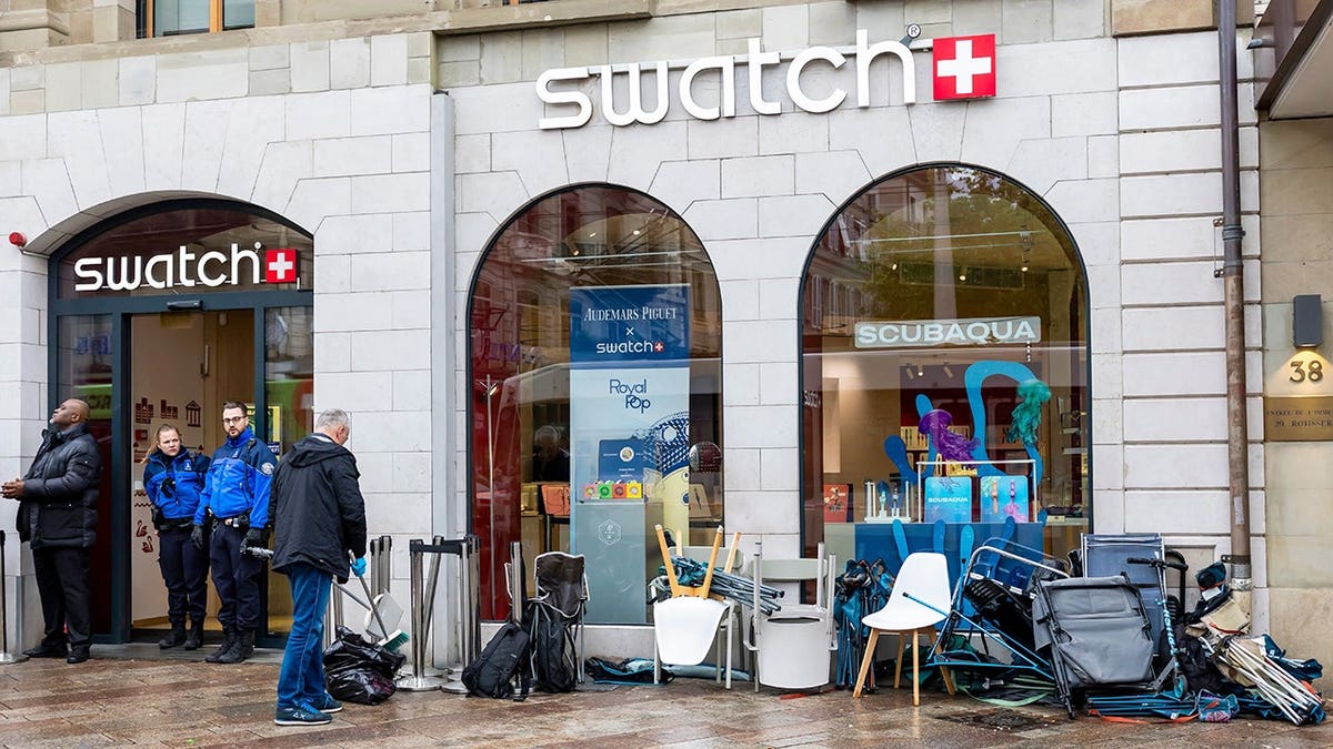 Swiss police officers securing area where customers queue to buy new Royal Pop watch in Geneva