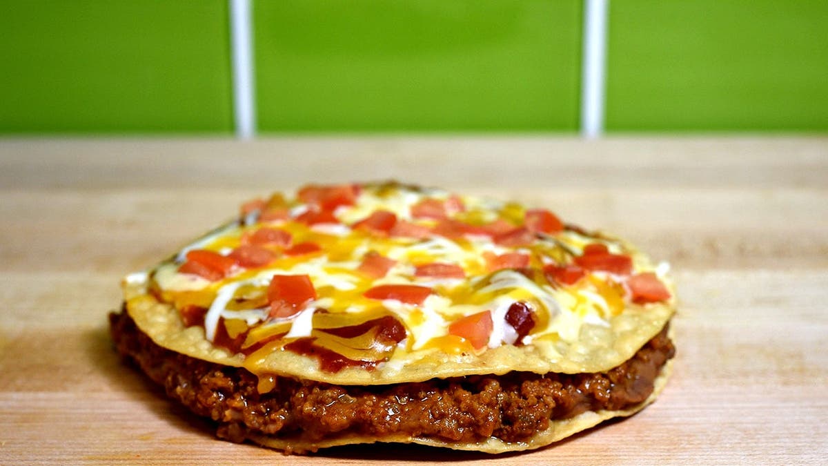 A Taco Bell Mexican pizza sits on a table.