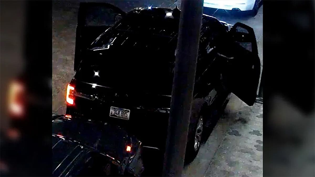 Black SUV showing the license plate