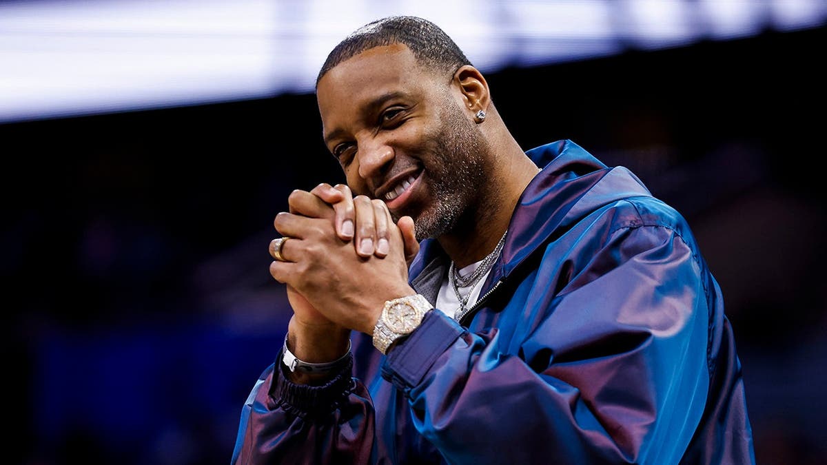 Tracy McGrady standing courtside at a basketball game in Orlando, Florida