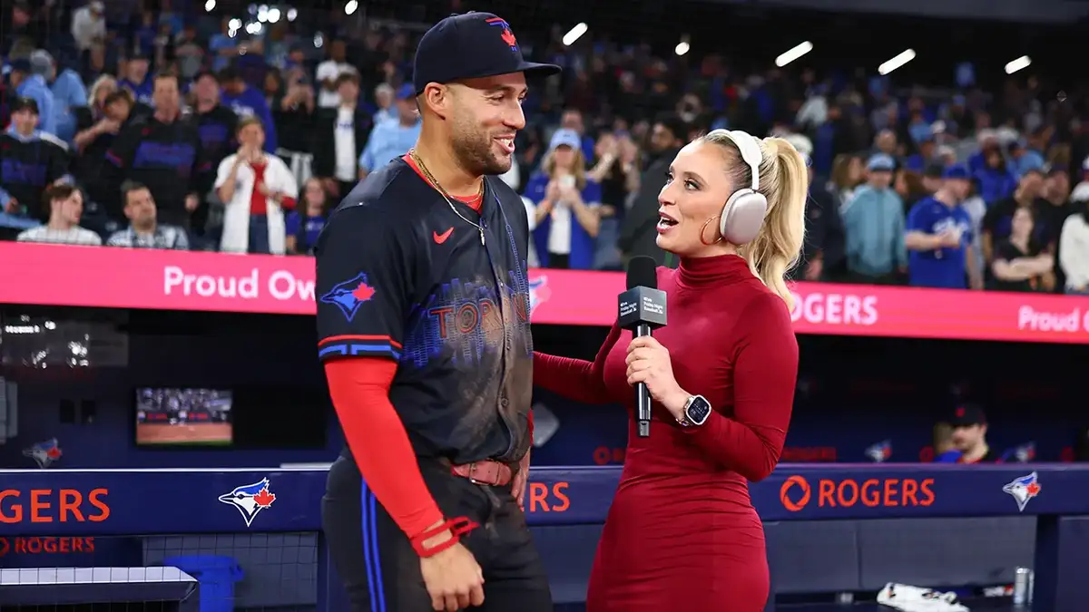 Tricia Whitaker interviewing George Springer on baseball field at Rogers Centre