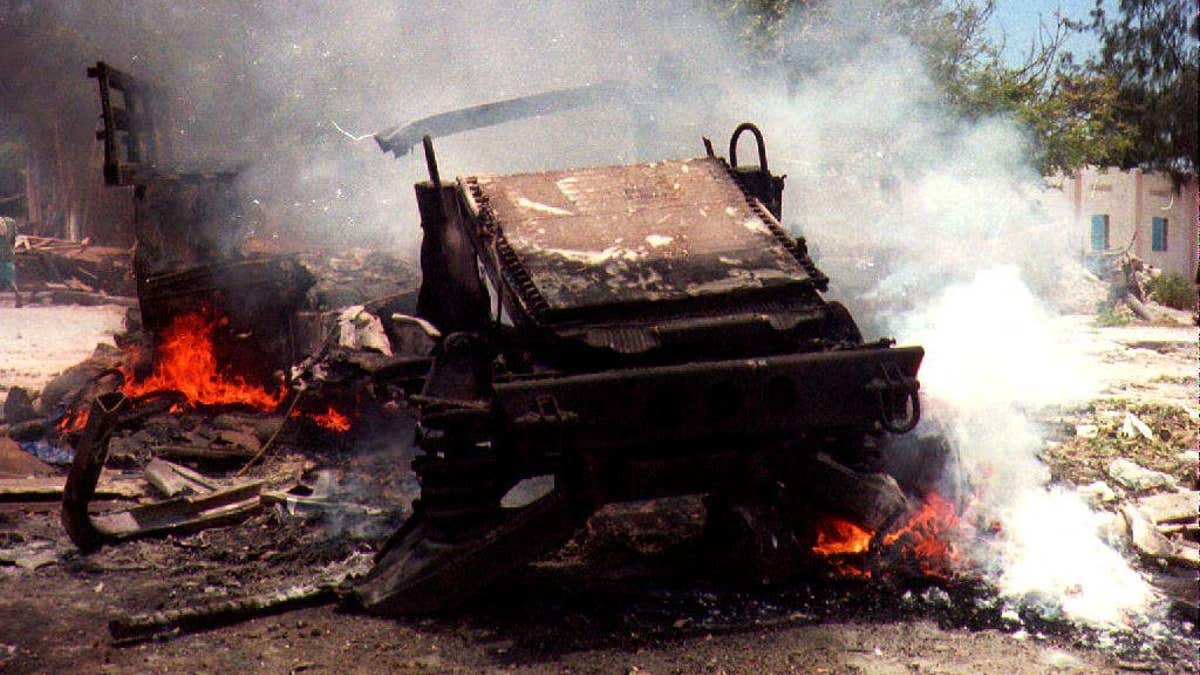 Wreckage of a burning U.S. military vehicle after bomb attack