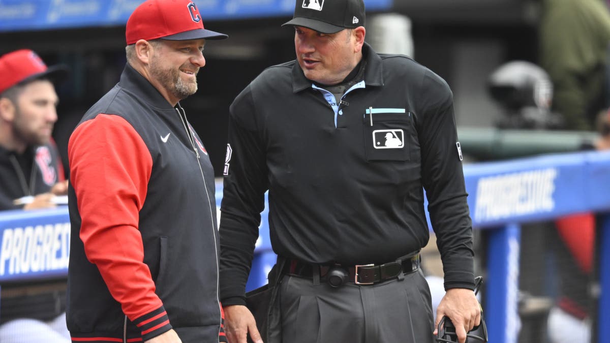 Apr 5, 2026; Cleveland, Ohio, USA; Cleveland Guardians manager Stephen Vogt (12) talks with home plate umpire Dan Bellino (2) during a game against the Chicago Cubs at Progressive Field. Mandatory Credit: David Richard-Imagn Images