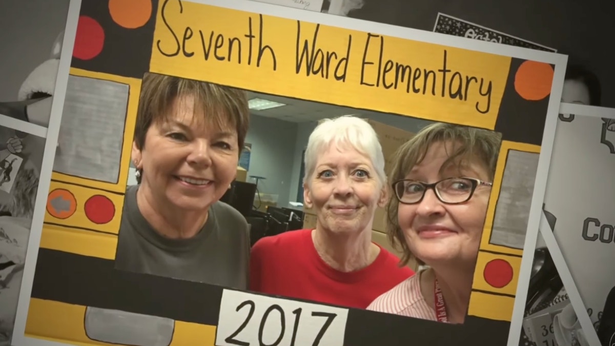 Katy Wells appears in a photo with two other women.