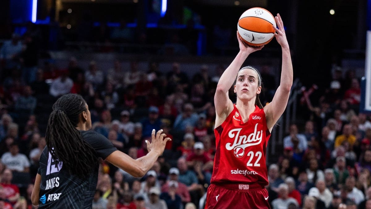 Indiana Fever guard Caitlin Clark shooting basketball defended by Golden State Valkyries guard Tiffany Hayes