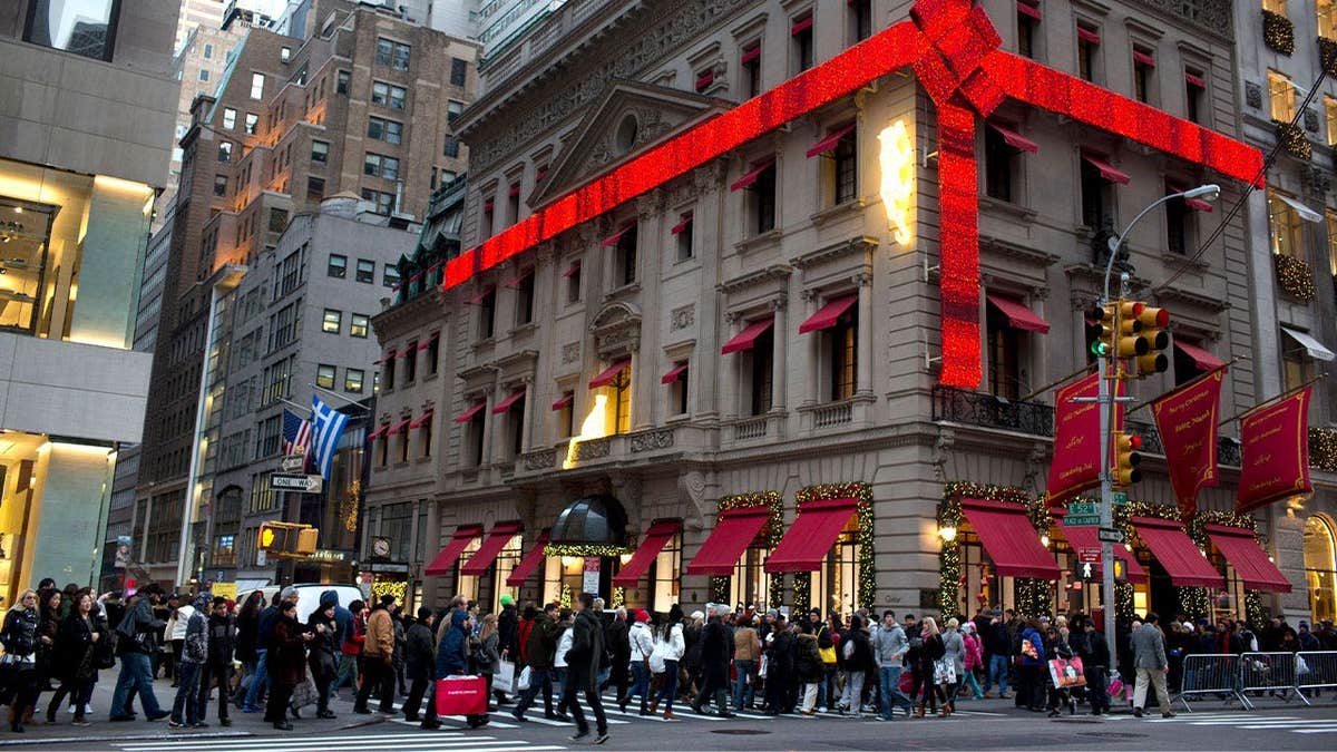 Shoppers assemblage the sidewalk astir the Cartier Mansion wrapped successful a reddish bow for the holidays, connected Fifth Avenue successful New York